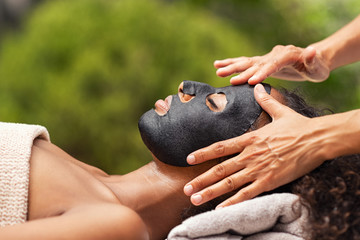 Wall Mural - Purifying black beauty mask on woman face