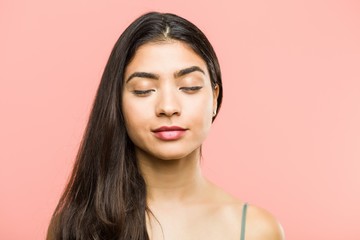 Wall Mural - Close up of a young beauty and natural arab woman closing her eyes