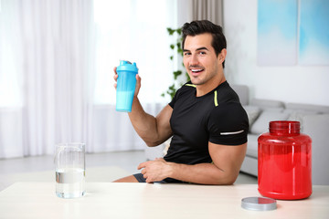 Sticker - Young athletic man with protein shake at home, space for text