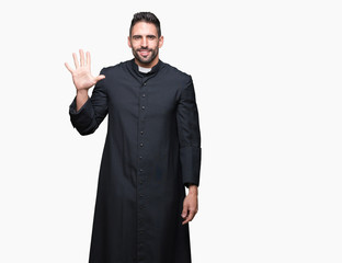 Young Christian priest over isolated background showing and pointing up with fingers number five while smiling confident and happy.