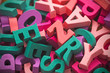 © Jakub Krechowicz - Pile of colorful painted wooden letters. Typography background composition.
