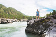 © olinchuk - Woman resting at river in Altai Mountains territory
