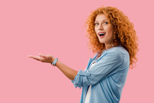 Beautiful Excited Woman Presenting Something Isolated On Pink