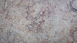 Texture of marble is multicolored with a large pattern-cracks, spots.