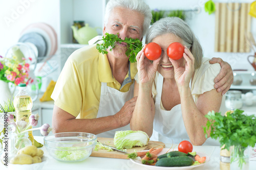 Portrait of a senior couple cooking together at kitchen Poster Mural XXL