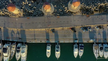 Wall Mural - Aerial View by Drone of Yacht Club and Marina. Top view of yacht club. White boats in sea water. Marina dock yachts and small motor boats. Yacht and sailboat is moored at the quay. Parking. Mandraki