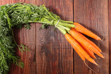 Sticker - fresh carrot and leaf on wood background