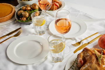 Wall Mural - festive thanksgiving dinner with baked vegetables and grilled turkey on white tablecloth