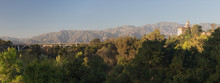 Panoramic View Of The Arroyo Seco, The Colorado Street Bridge, And The Richard H. Chambers Courthouse Against The San Gabriel Mountains In Pasadena. 