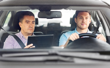 Wall Mural - driver courses and people concept - man and driving school instructor with tablet computer in car