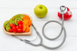 © freebird7977 - Diet and weight loss for healthy care with medical stethoscope, vegetable fruit and healthy food with red heart on the old white wooden background top view. Healthy Concept.