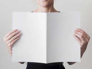 Woman holding a mock-up magazine