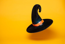 Black Witch Hat On Blank Orange Background.
