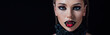 panoramic shot of scary vampire girl with fangs isolated on black