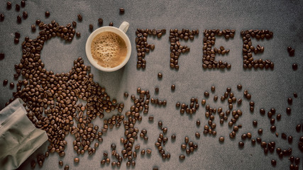 Text formed from coffee beans and coffee cup morning energy