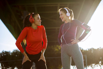 Two young women doing gymnastic exercises outdoor