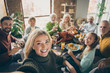 Leinwandbild Motiv Photo of big family sit feast dishes table around roasted turkey multi-generation relatives making group selfies raising wine glasses juice in living room indoors
