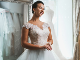 Wall Mural - Beautifu bride choosing wedding dress in a wedding salon