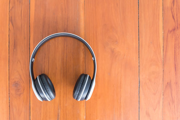 White wireless Headphones placed on a wooden table