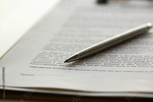 Fotomural Silver pen lying on form clipped to pad closeup background