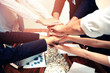 © komkrit - Close up  of young business people putting  hands for success project