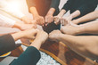 © komkrit - Close up  of young business people putting  hands for success project