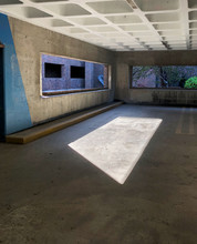 Sunlight Enters An Empty Parking Structure Through A Window Painting A Rectangle On The Ground.