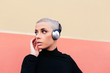 © Lucas Ottone/Stocksy - Woman wearing headphones