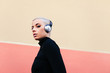© Lucas Ottone/Stocksy - Woman wearing headphones