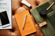© leandro crespi/Stocksy - Orange notebook surround by woman lifestyle items