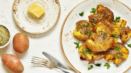 Canvas Print - crushed potatoes. smashed potatoes. recipes for Australian cuisine. the potatoes are boiled in a shell, broken and baked in an oven with spices. top view