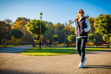 Wall Mural - middle-aged woman walking in city park