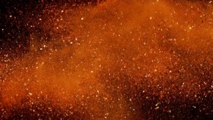 Exotic Spices paprika variation collide on black background closeup in super slow motion