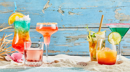 Exotic summer drinks on white sand