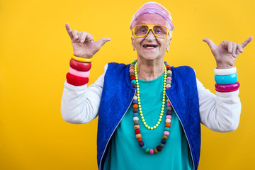 Wall Mural - Funny grandmother portraits. 80s style outfit. trapstar dance on colored backgrounds. Concept about seniority and old people