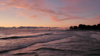 Wall Mural - gorgeous panoramic landscape view of a colorful blue pink and purple sunrise over the water of lake 