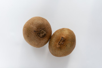 two kiwi fruits on a white background