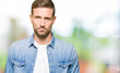 © Krakenimages.com - Handsome man with blue eyes and beard wearing denim jacket depressed and worry for distress, crying angry and afraid. Sad expression.
