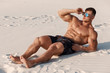 © nikolas_jkd - Muscular man on the beach enjoying summer sun and tanning. Strong male naked torso abs outdoors