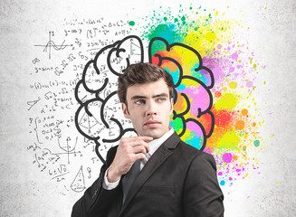Wall Mural - young man in suit, left and right brain concept