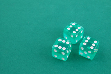 Three dices on green gaming table, gambling concept