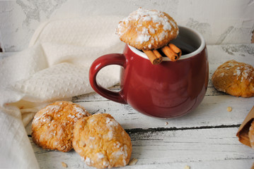 Cup with hot coffee and cookies on a white wooden table. Homemade baking.