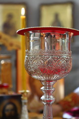 Orthodox churches. A silver cup for communion, a prosphora for the preparation of the sacred mystery of the Eucharist, and sweet wine on the table on the throne.