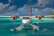 © icemanphotos - Exotic scene with seaplane on Maldives sea landing. Seaplane taxi on sunset sea before takeoff. Vacation or holiday in Maldives concept background. Air transportation