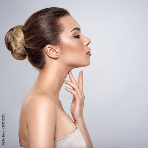 Fotomural beautiful woman who touches the neck by fingers