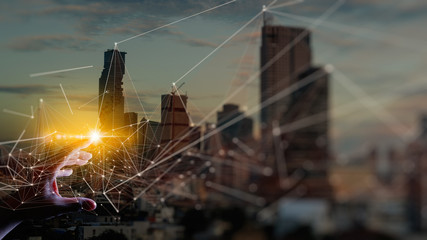 Fototapete - Woman hand touching Wireless network and Connection technology elements covering on Abstract building city.