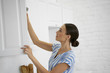 © Yakobchuk Olena - Calm young lady opening the cupboard stock photo