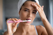 © Yakobchuk Olena - Sad young Caucasian woman brushing her teeth