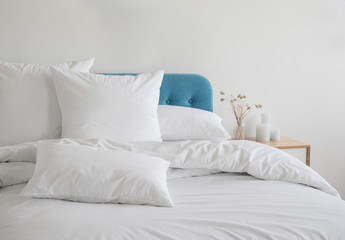 white pillows and duvet on the blue bed. white pillows, duvet and duvet case on a blue bed. white be