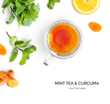 Creative Layout Made Of A Cup Of Mint Tea And Curcuma On A White Background. Top View.